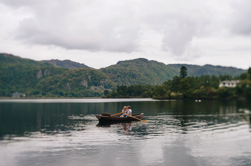 couple take turns in rowing wooden rowing boat