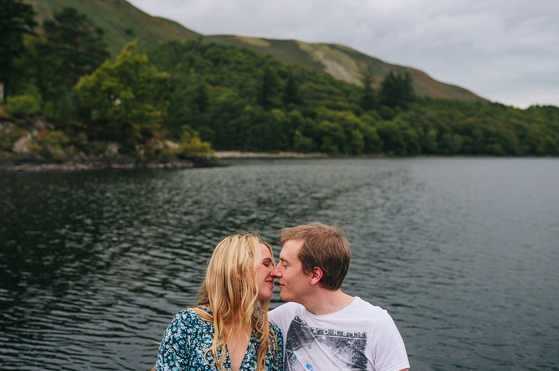 kissing portrait on the back of a boat, surrounded by water