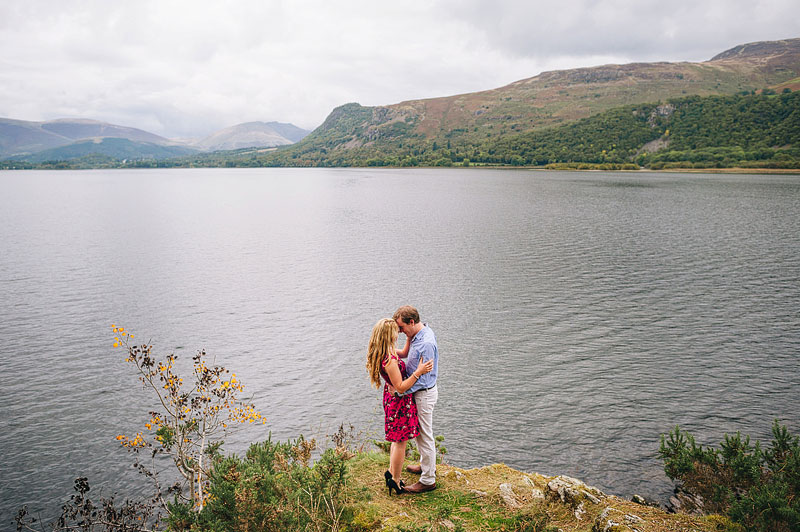 intimate engagement photo of young couple overlooking the lake 