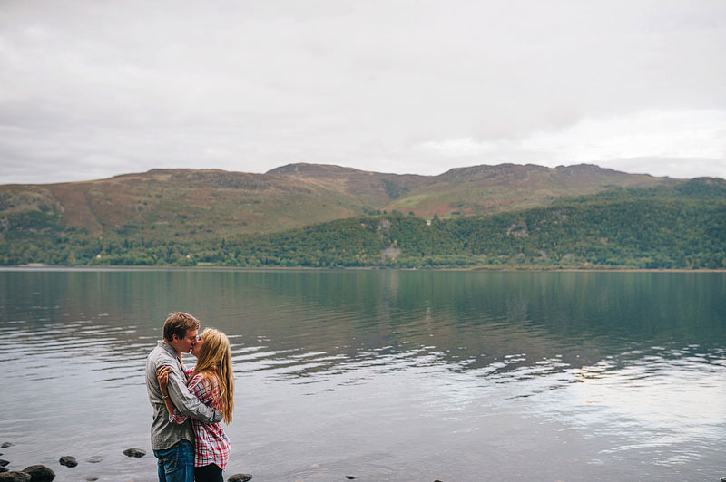 couple embrace in front of the lake