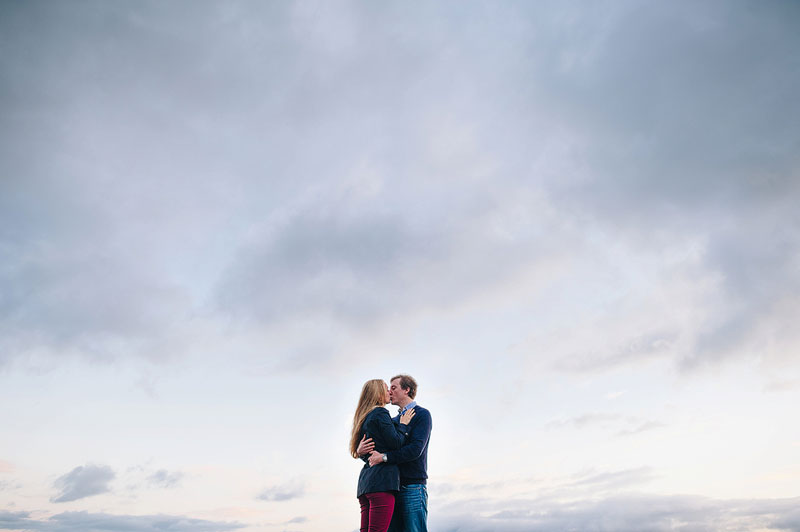 Couple cuddling, shot against the sky