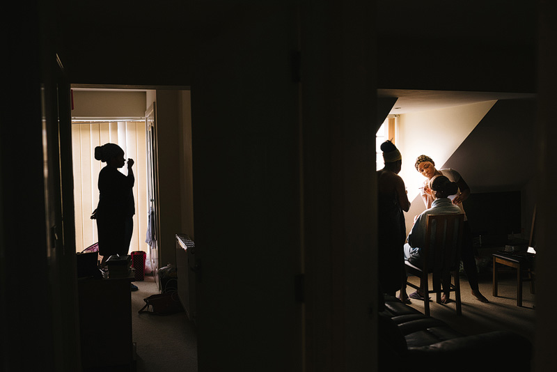 clever photo of bride and bridesmaids getting ready in separate rooms