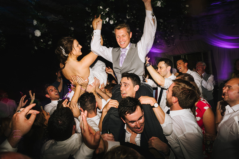 bride and groom crowd surfing