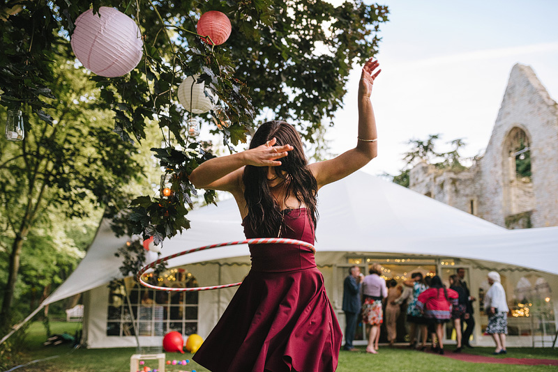 girl hula hooping at festival wedding