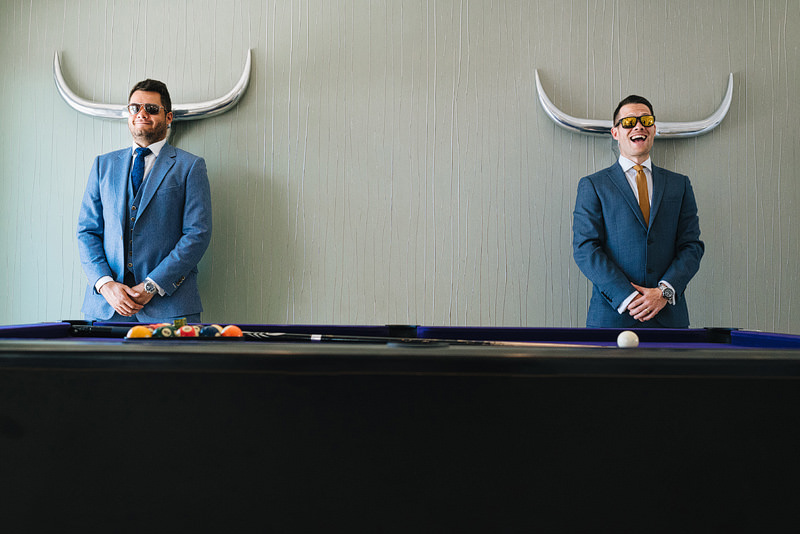 groomsmen being silly, pretending antlers are coming out of thei