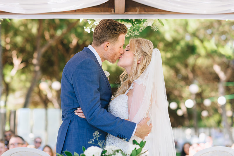 couple enjoy their first kiss as newlyweds