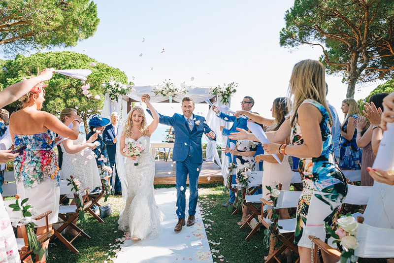 guests shower the couple with confetti during the recessional