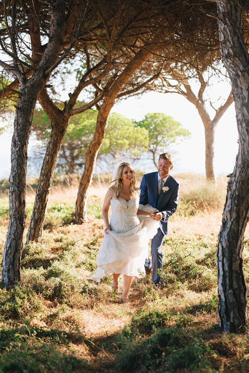 newlyweds walking through trees in the most beautiful algarvian
