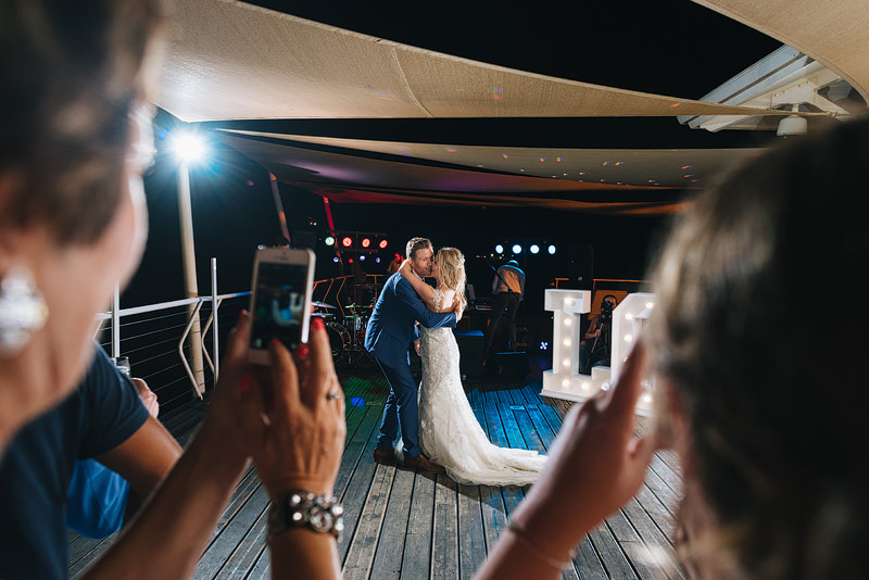 guests take photos of the first dance