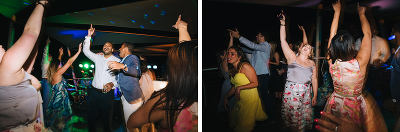 wedding guests partying and singing at beach bar