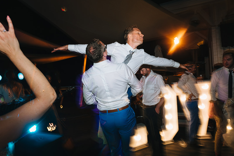 best man lifts the groom high into the air whilst dancing