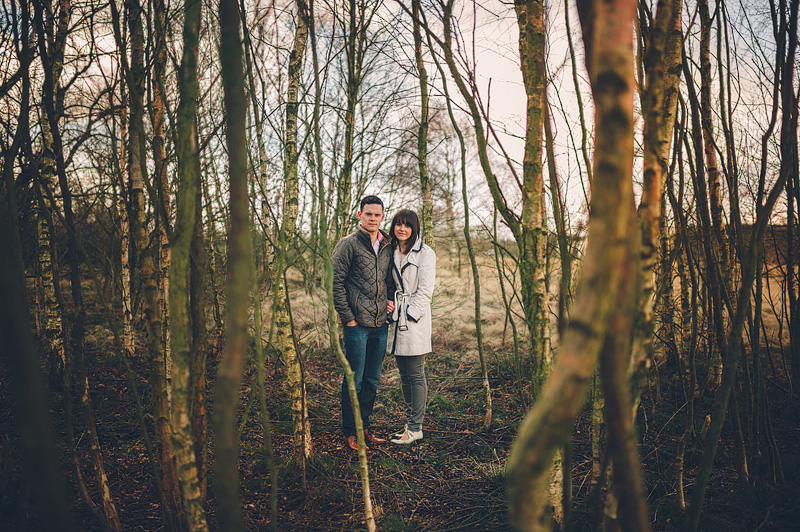 Engagement photos of loving couple in amongst the trees