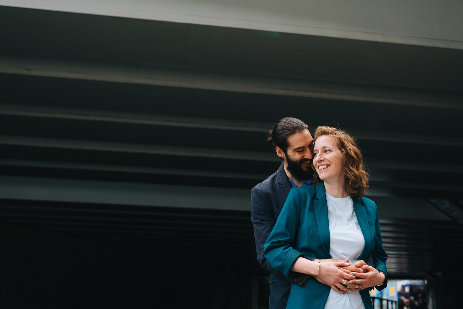 couple hug under canal bridge