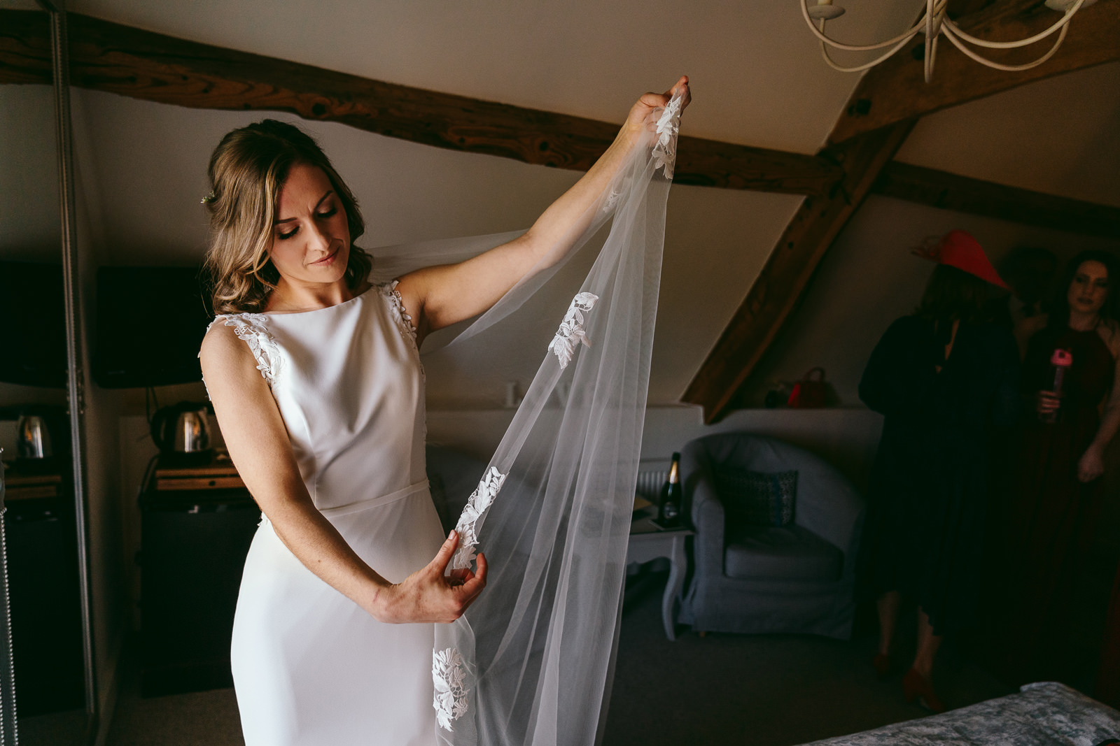 the bride adjusts her veil