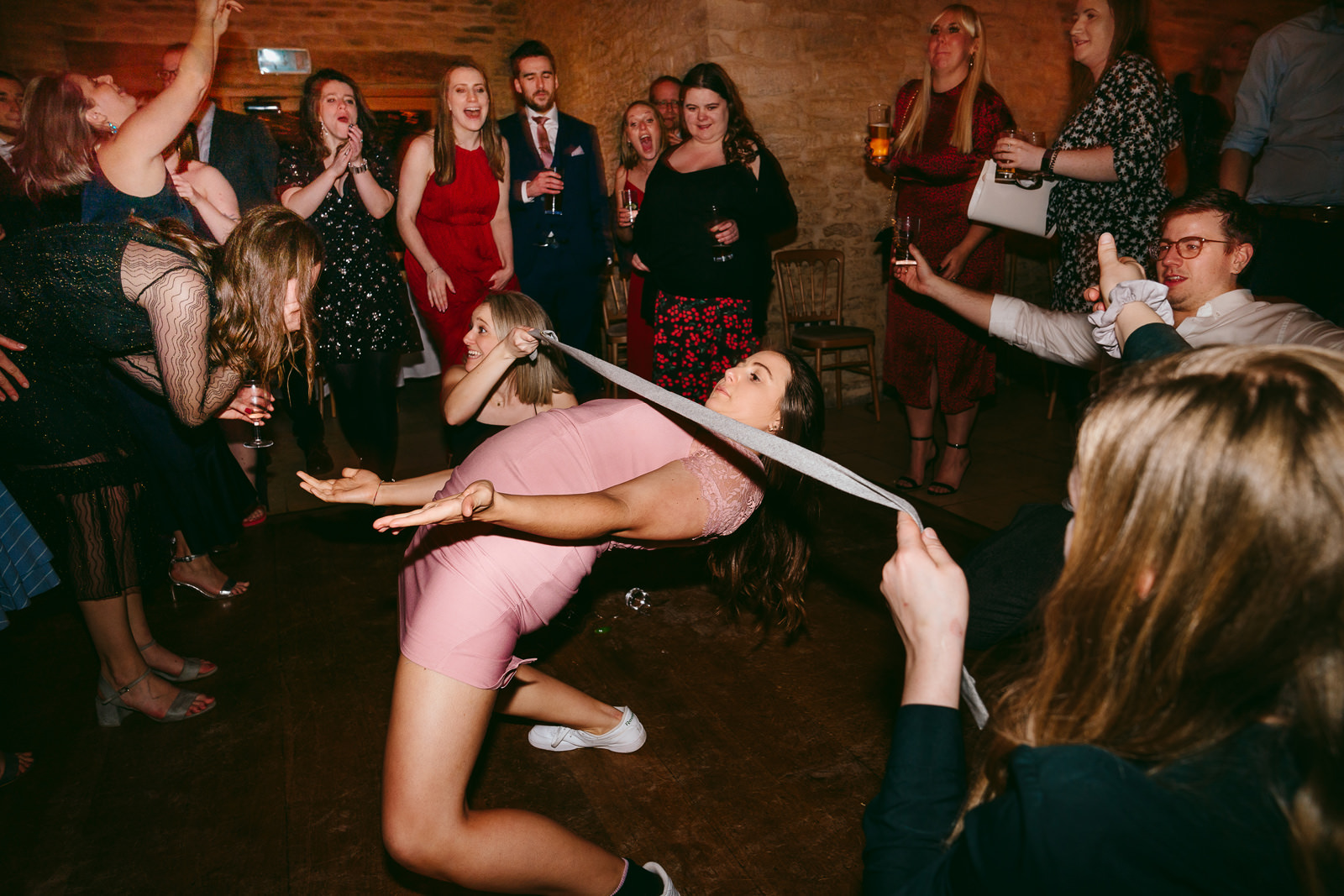 wedding guests doing limbo