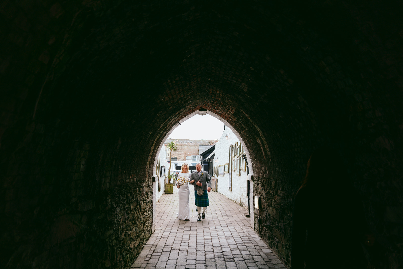 Bride and her father about to walk through the tunnel